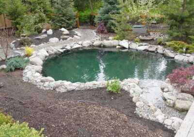 This koi pond was constructed with a bottom drain, skimmer, bead filter, in-line pump, U.V. sterilizer, and a turbo vortex solids separator.