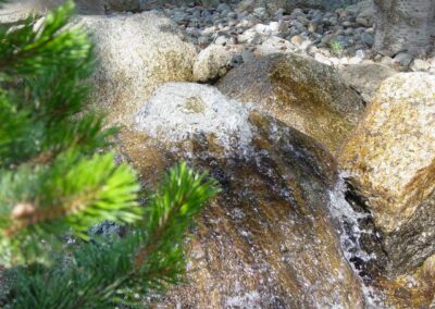 A rock fountain gives great affect to a pond while providing the soothing sensation of flowing water.