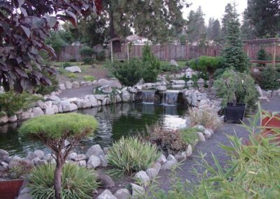 This Koi Pond has over a 50 foot stream running into the upper pond that holds approximately 3,000 gallons and then pours into the main pond of 8,000.
